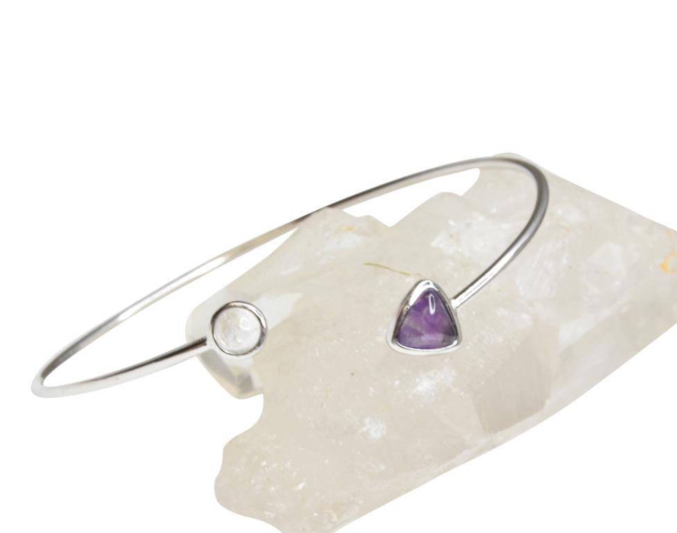 Simple silver bracelet with amethyst gemstone on one end and quartz on the other