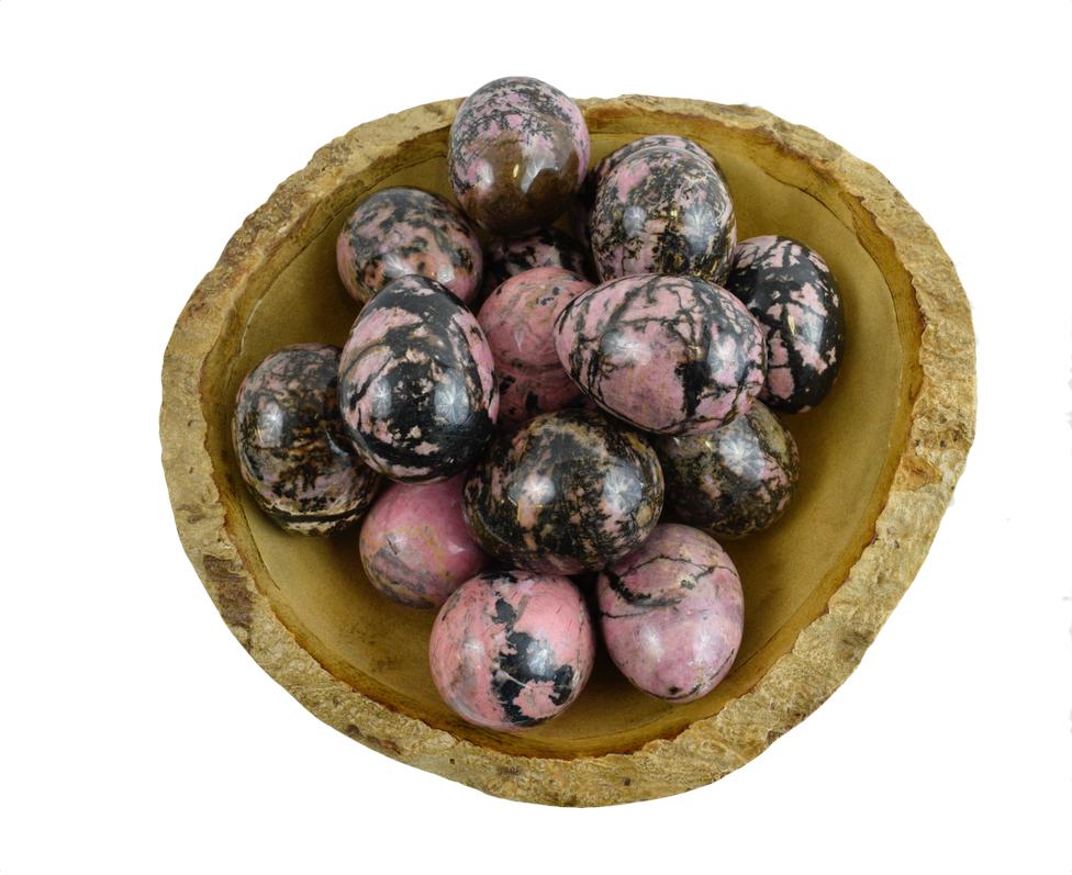 Bowl of Rhodonite Yoni Eggs to show stone color variations 